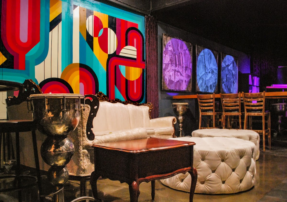 Vintage lounge and mural inside Trickster's Hideout